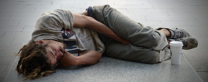 Backpacker sleeping on street