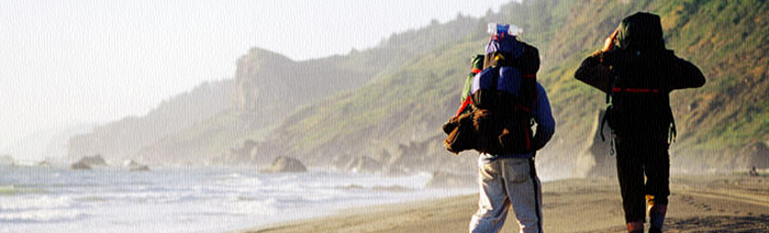 Backpacker walking on a beach